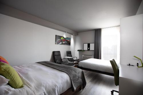 a hotel room with two beds and a window at Hotel V in Gatineau