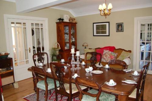 a dining room with a table and a couch at Teach An Easard in Clifden