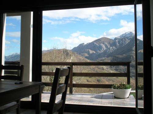 balcón con mesa, sillas y vistas a las montañas en La Senda del Casaño, en Canales