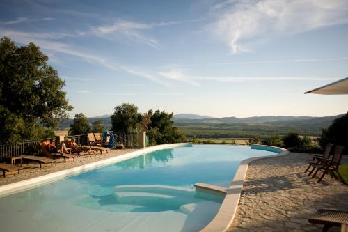 a swimming pool with a view of the mountains at Tenuta il Sassone - Wine&Food in Massa Marittima