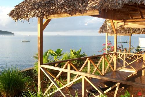 a hut with a view of the ocean at L'heure Bleue in Ambatoloaka