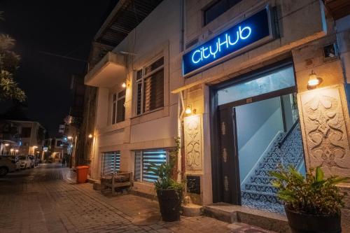 a building with a blue sign on the side of it at CityHub in Antalya