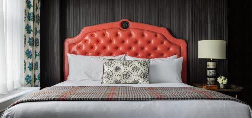 a bed with a red headboard in a room at Graduate by Hilton Providence in Providence