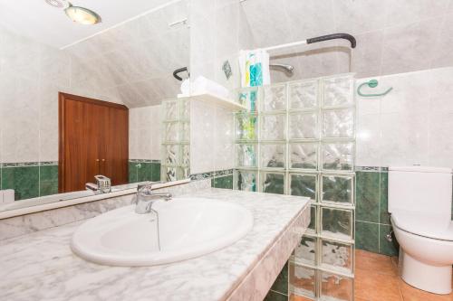 a bathroom with a sink and a toilet at HomeHolidaysRentals Corts in Tordera