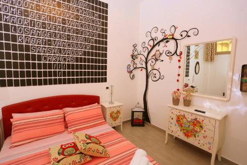 - une chambre avec un lit doté d'une tête de lit rouge et d'un miroir dans l'établissement A Casa di Giorgia "Beautiful House" a Nardò nel Salento, à Nardò