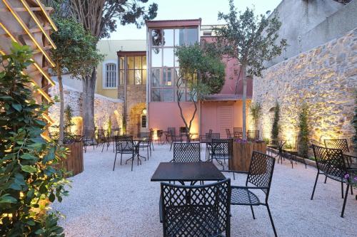 a group of tables and chairs in a courtyard at Agora Residence in Chios