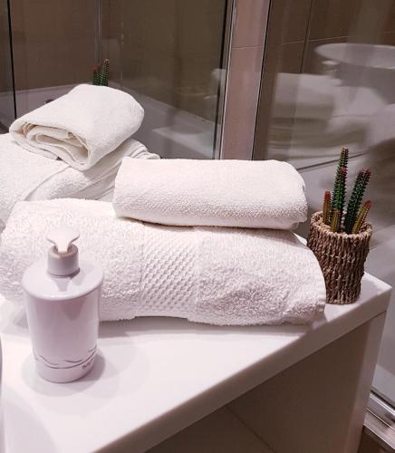 a pile of towels on a counter in a bathroom at Alexander Beach Punta del Este in Punta del Este