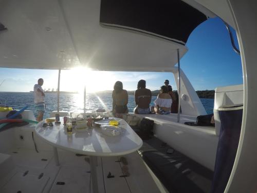a group of people sitting on a boat at Wikkid Resort in Dixon Cove
