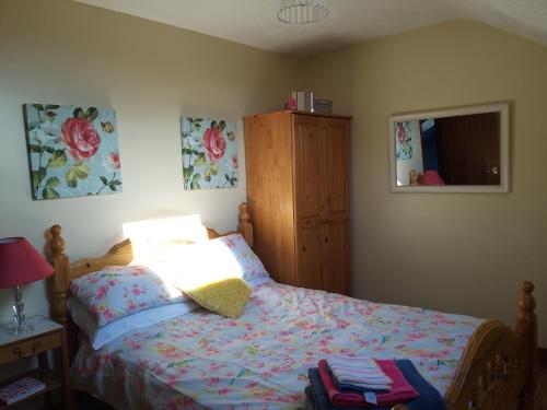 a bedroom with a bed and a dresser at Antrim Heights Estate in Antrim