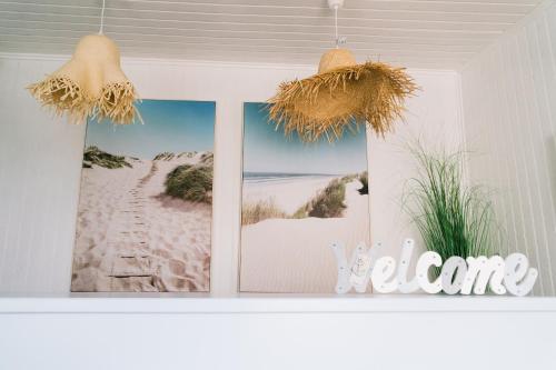three pictures hanging on a wall in a room at NorthSpot in Nazaré