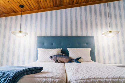 a bed with a fish stuffed animal on it at NorthSpot in Nazaré