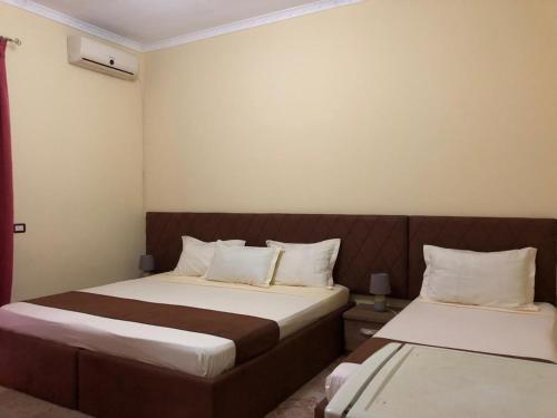 En eller flere senge i et værelse på Vogli's House Apartments & Rooms