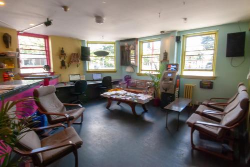 a living room with chairs and a table in a room at Ocean Island Inn | Backpackers | Suites in Victoria