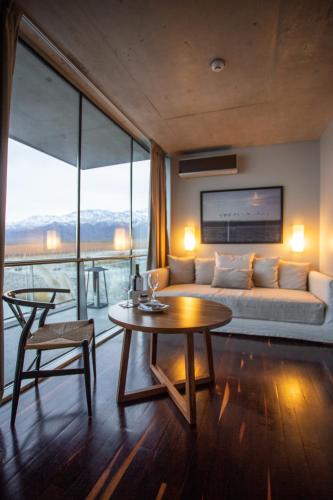 a living room with a couch and a table at Casa de Uco Vineyards and Wine Resort in Los Árboles