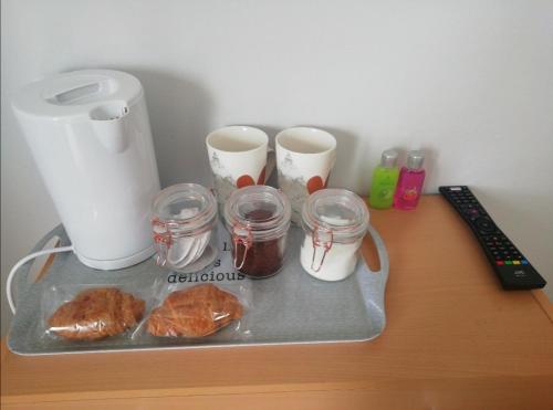 a table with a tray with croissants and cups on it at Private bedroom in a detached bungalow in Porthmadog