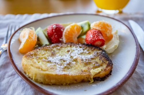 a plate of food with toast and fruit on it at Casa de Uco Vineyards and Wine Resort in Los Árboles