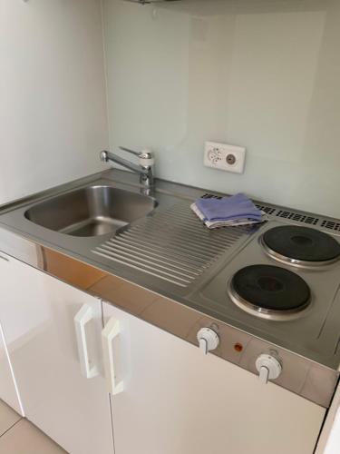 a kitchen with a sink and a stove at Ustria / Pensiun Trutg in Vella
