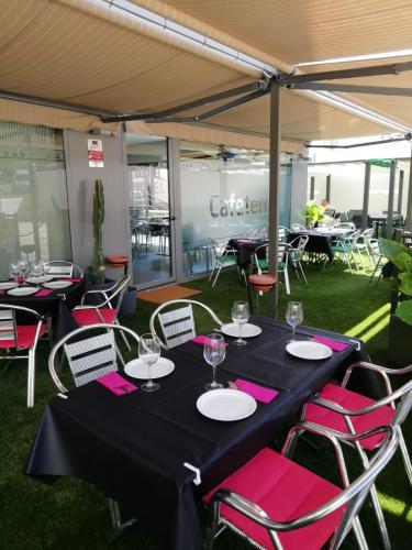 a group of tables and chairs under a tent at Sercotel Aura Algeciras in Algeciras
