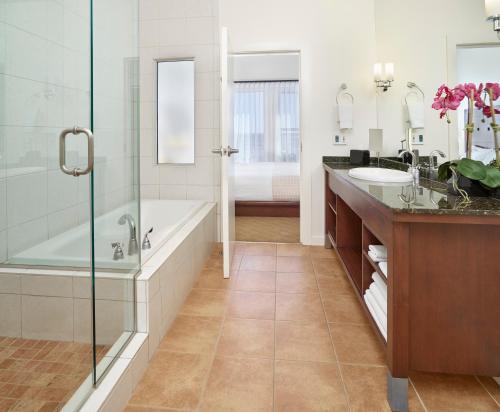 La salle de bains est pourvue d'une baignoire et d'un lavabo. dans l'établissement Metterra Hotel on Whyte, à Edmonton