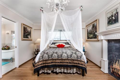 a bedroom with a bed and a chandelier at Diana's Luxury Bed and Breakfast in Vancouver