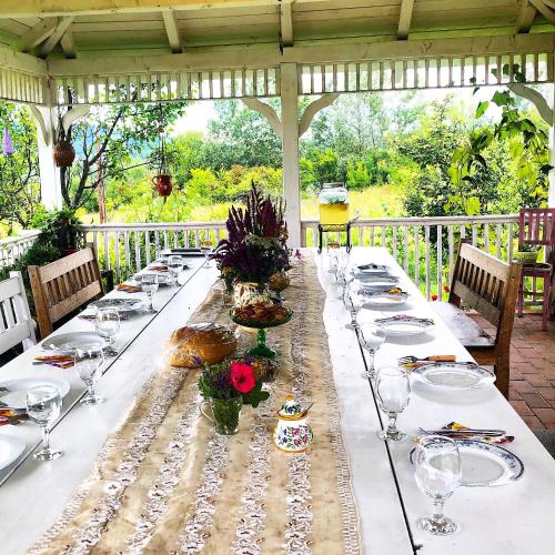 a long table with plates of food on it at Conacul Paloși in Horezu