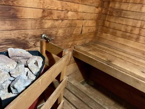 a sauna with two benches and rocks in it at Deluxe Inn in Toronto