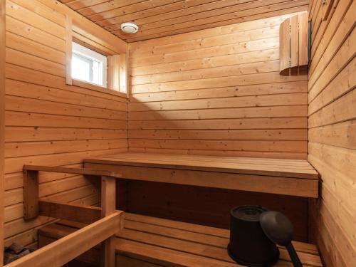 a wooden sauna with a bench in it at Hotel Jahtihovi in Kuopio