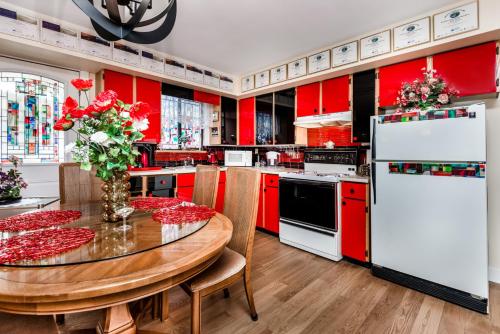 a kitchen with red cabinets and a wooden table at Diana's Luxury Bed and Breakfast in Vancouver