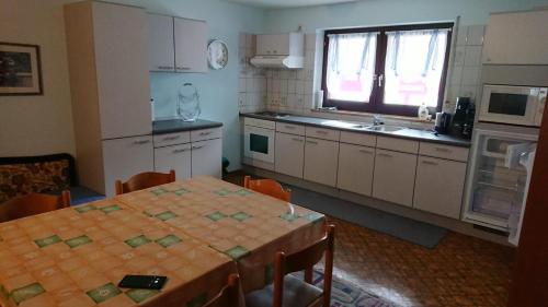 Rinken的住宿－Kaufhaus Feldberg，厨房配有桌子、水槽和桌椅