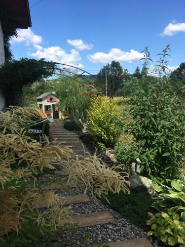 a garden with rocks and plants and a house at Apartamenty Lawenda in Rabka