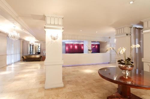 a large room with a table and a couch at Manhattan Hotel in Pretoria