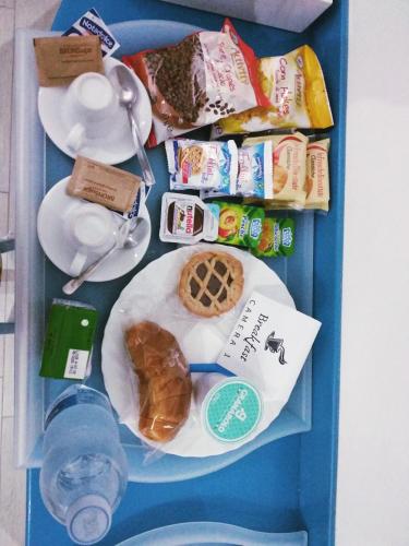 a tray of food with a plate of food at ControVento Rooms in Margherita di Savoia