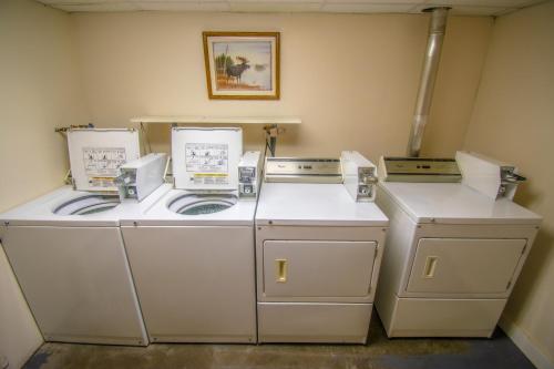 three washing machines are sitting in a room at Attitash Mountain Village in Bartlett