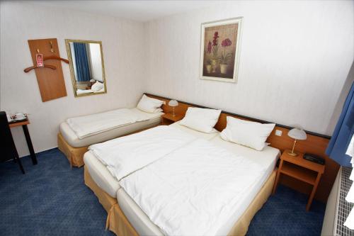 Łóżko lub łóżka w pokoju w obiekcie Gästehaus Am Vogelsang