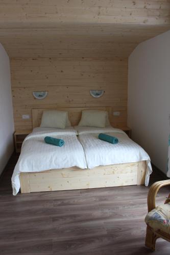 a wooden bed with two pillows on it in a room at Pension INGE in Hinterstoder