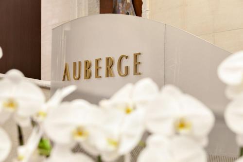 a sign for an office with white flowers at Auberge Vancouver Hotel in Vancouver