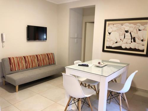 a living room with a table and chairs and a couch at La Pedrera in Villa María