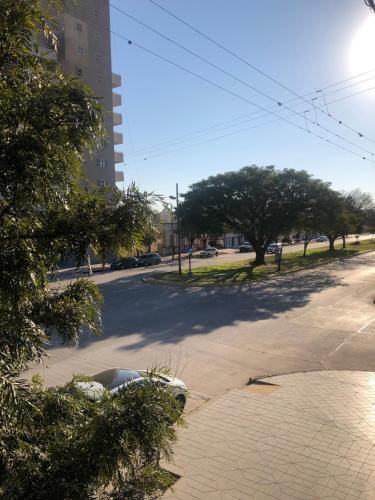 an empty street with trees on the side of the road at La Pedrera in Villa María