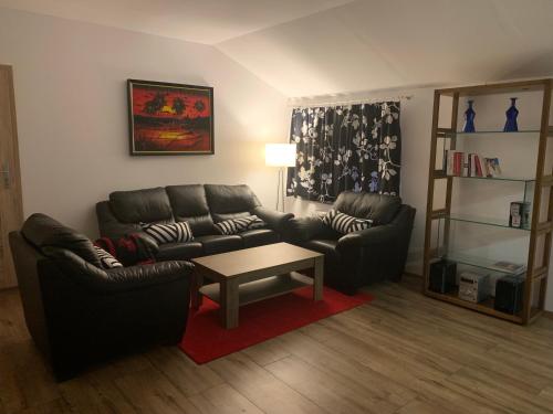 a living room with two couches and a coffee table at Apartamenty Podwarszawskie in Stara Wieś