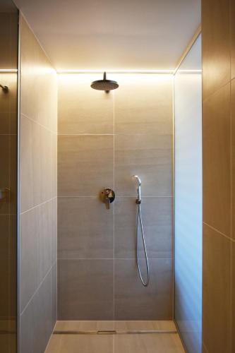 a bathroom with a shower with a glass door at Bed&Breakfast Monte Rosso in Poreč