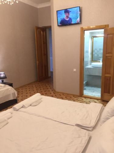 a hotel room with a bed and a mirror at HOTEL COMFORT in Kutaisi