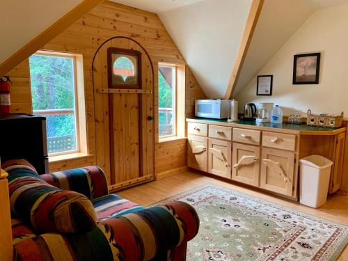 a kitchen in a log cabin with a counter top at Sourdough Sunrise B&B in Seward