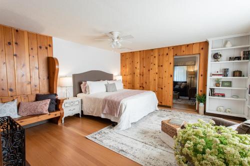 a bedroom with a bed and a living room at Hummingbird Estate in Central Point