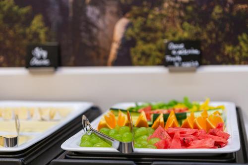 a plate of fruit and vegetables on a table at Bohemia Inn Hotel in Turnov