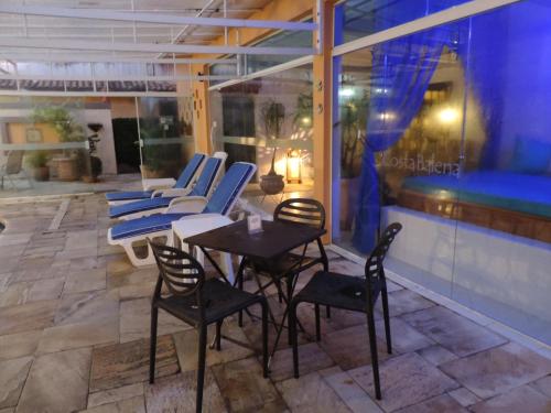 a patio with chairs and a table on a building at Hotel Costa Balena-Piscina Aquecida Coberta in Guarujá