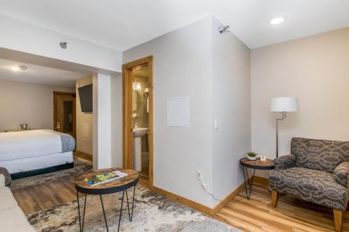 a hotel room with a bed and a couch at Grey Fox Inn in Stowe