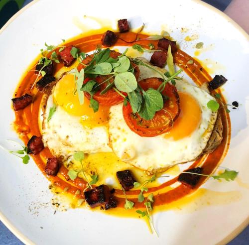 a plate of food with eggs and vegetables on it at The Red Lion Hotel in Oakford