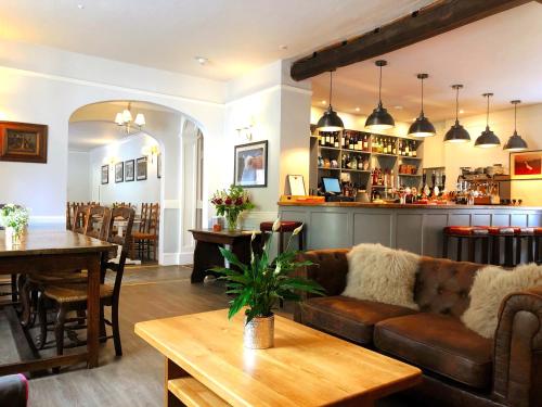 a living room with a couch and a table at The Red Lion Hotel in Oakford