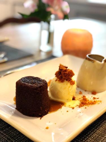 a piece of chocolate cake and ice cream on a plate at The Red Lion Hotel in Oakford