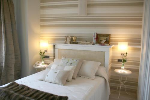 a bedroom with a white bed with two night stands at Hotel Castillo de Alquézar in Alquézar